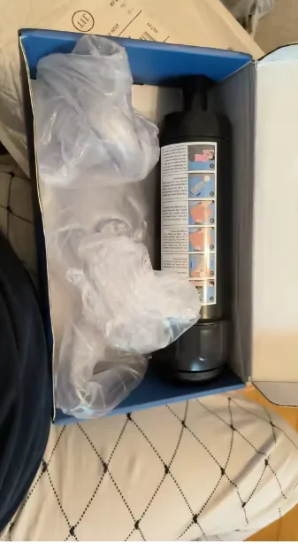 Customer-submitted photo showing the device and masks packed inside the box